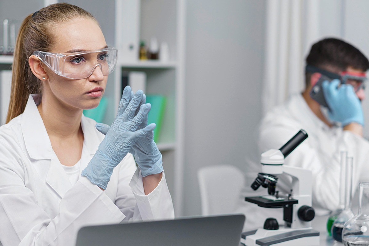female researcher laboratory with safety glasses