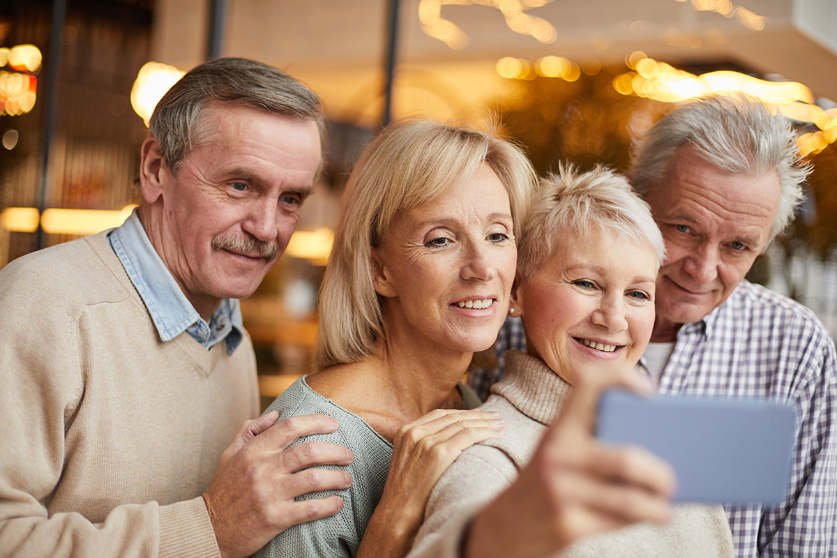 group senior friends taking photo social media